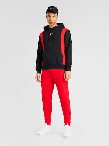 Nike Sportswear Tapered Παντελόνι 'TCH FLEECE' σε κόκκινο