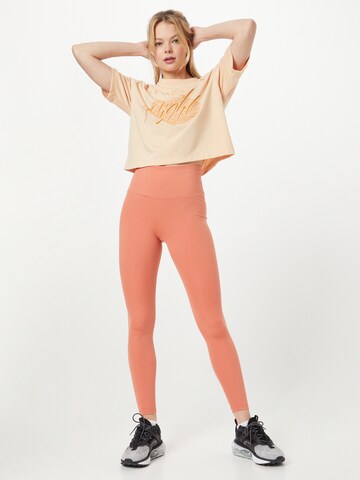 NIKE Skinny Športne hlače 'One' | oranžna barva