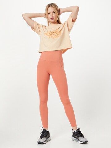 NIKE Skinny Športové nohavice 'One' - oranžová