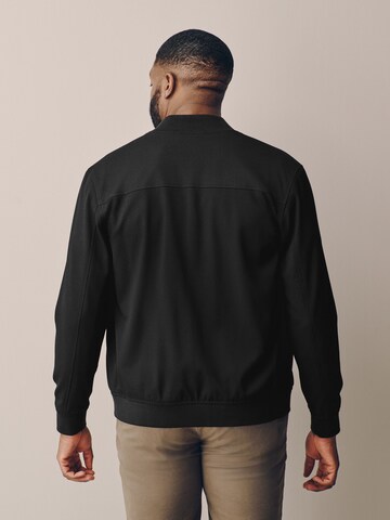 Next - Chaqueta de entretiempo 'Motionflex' en negro
