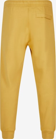 Nike Sportswear Zúžený Kalhoty 'Club Fleece' – žlutá
