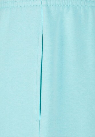 Tapered Pantaloni di Urban Classics in blu