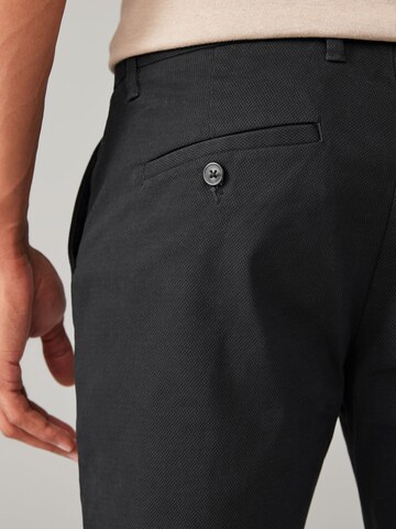 Slimfit Pantaloni chino di Next in nero