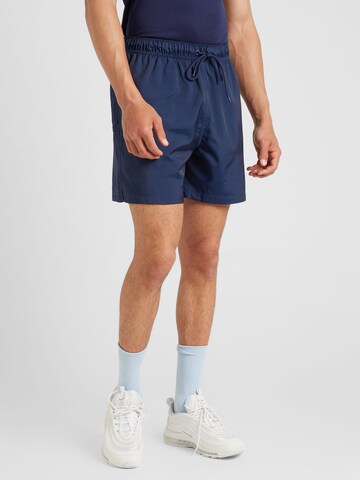 Largi Pantaloni 'Club' de la Nike Sportswear pe albastru: față