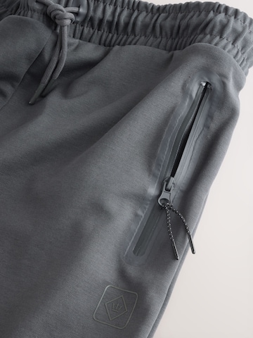 Next Дънки Tapered Leg Панталон в сиво