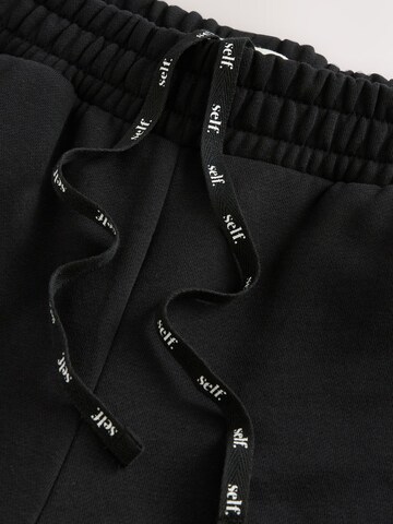Next - Tapered Pantalón en negro