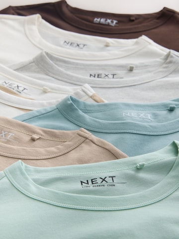 Tricou de la Next pe bej