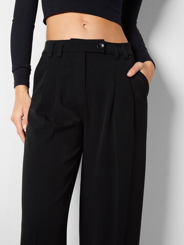 Bershka Loose fit Pleat-front trousers in Black