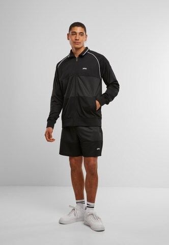 Unfair Athletics Between-season jacket 'Center Court Tracktop' in Black