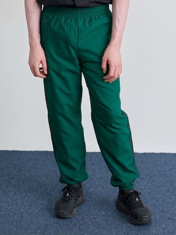 ADIDAS ORIGINALS Tapered Trousers in Green: front