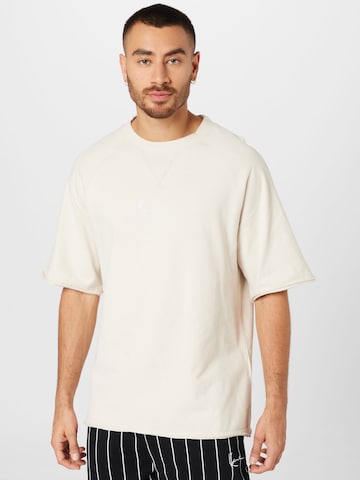 T-Shirt Karl Kani en beige : devant