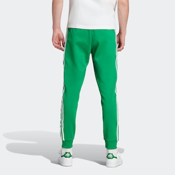 ADIDAS ORIGINALS Tapered Trousers 'Adicolor Classics Sst' in Green