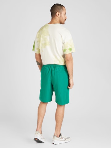 Nike Sportswear Loose fit Pants 'CLUB' in Green