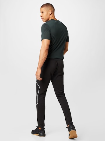 ADIDAS SPORTSWEAR Regular Urheiluhousut 'Essentials Reflect-In-The-Dark Fleece' värissä musta