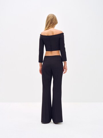 ABOUT YOU x Toni Garrn Flared Pleated Pants 'Elonie' in Black