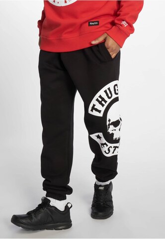 Thug Life Tapered Pants in Black: front