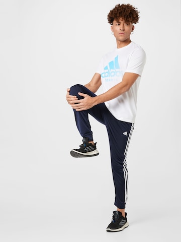 ADIDAS SPORTSWEAR Zúžený Sportovní kalhoty 'Essentials Warm-Up Tapered 3-Stripes' – modrá