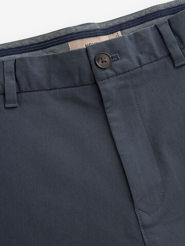 Next Slimfit Chinohousut värissä sininen