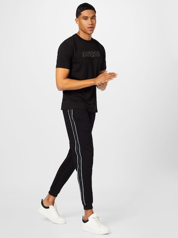 GUESS - Tapered Pantalón 'Mickey' en negro