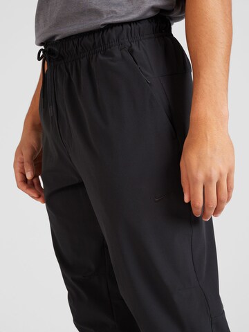 NIKE Tapered Sports trousers 'Unlimited' in Black