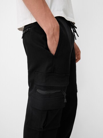 Bershka Tapered Cargo trousers in Black