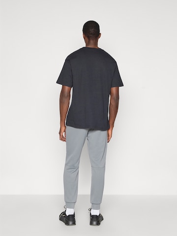 NIKE Tapered Sportnadrágok 'FLEX' - szürke