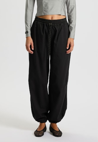 rethinkit studios Loose fit Pants 'Palma Move' in Black: front