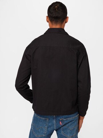 Tommy Jeans Between-Season Jacket 'Harrigton' in Black