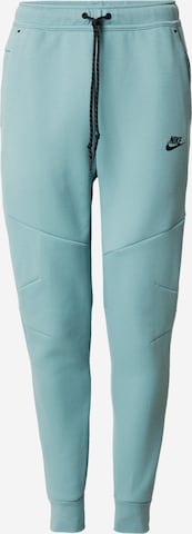 žalia Nike Sportswear Siaurėjantis Kelnės 'TCH FLC': priekis