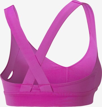 PUMA Medium Support Sports bra 'Own It' in Pink