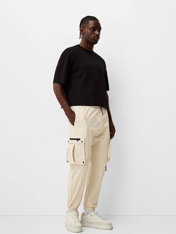 Bershka Tapered Cargobyxa i beige