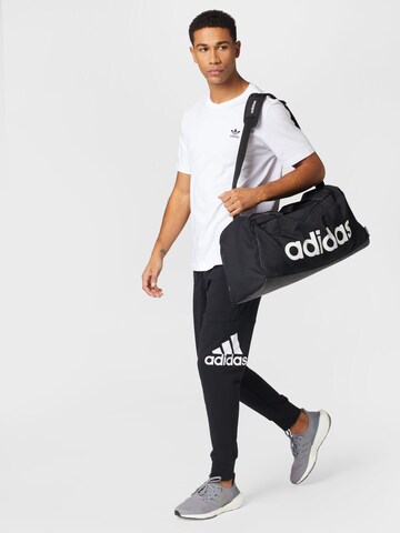 ADIDAS SPORTSWEAR Конический (Tapered) Спортивные штаны 'Essentials' в Черный