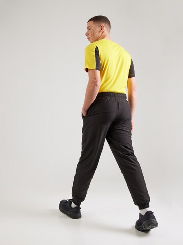 PUMA - Tapered Pantalón deportivo 'Borussia Dortmund FtblArchive' en negro