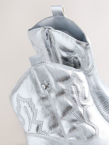 Next - Botas en plata