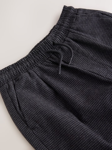 Loosefit Pantaloni di Next in grigio