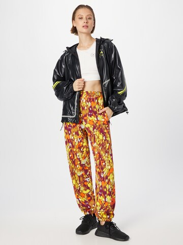 Effilé Pantalon de sport 'Floral Printed ' ADIDAS BY STELLA MCCARTNEY en orange