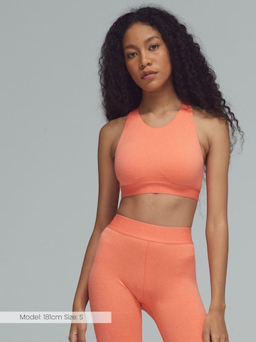 DRILLS Apparel High neck Sports Bra in Orange: front