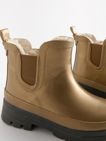 Next - Botas de lluvia en oro