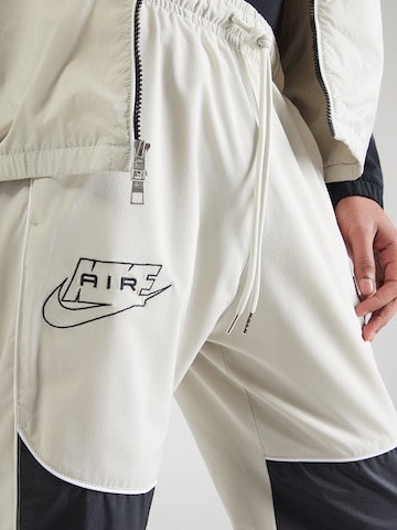 pelēks Nike Sportswear Pakapēniski sašaurināts piegriezums Bikses 'AIR'