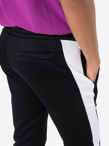 PUMA - Tapered Pantalón en negro