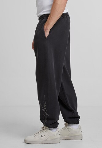 Effilé Pantalon 'Autograph' Karl Kani en noir