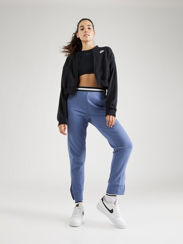 NIKE Tapered Sports trousers in Blue