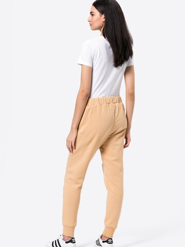 Tapered Pantaloni sportivi 'TARA' di FILA in beige