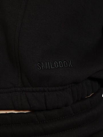 Veste de survêtement ' Elma ' Smilodox en noir