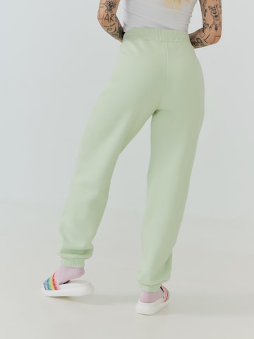 ABOUT YOU x Sharlota Tapered Pants 'Nala' in Green