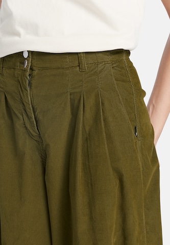 TIMBERLAND Široke hlačnice Hlače 'Needle Corduroy Wide Leg Pant' | zelena barva