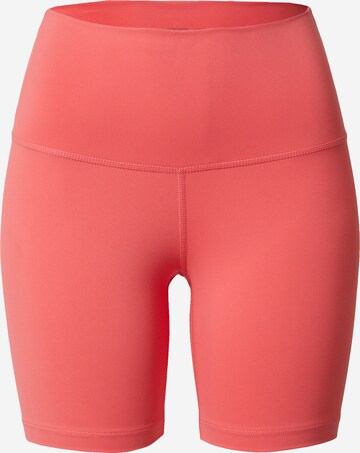NIKE Skinny Workout Pants in Orange: front