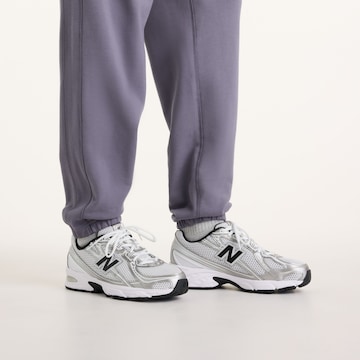 Loosefit Pantaloni 'Athletics French Terry Jogger' di new balance in lilla